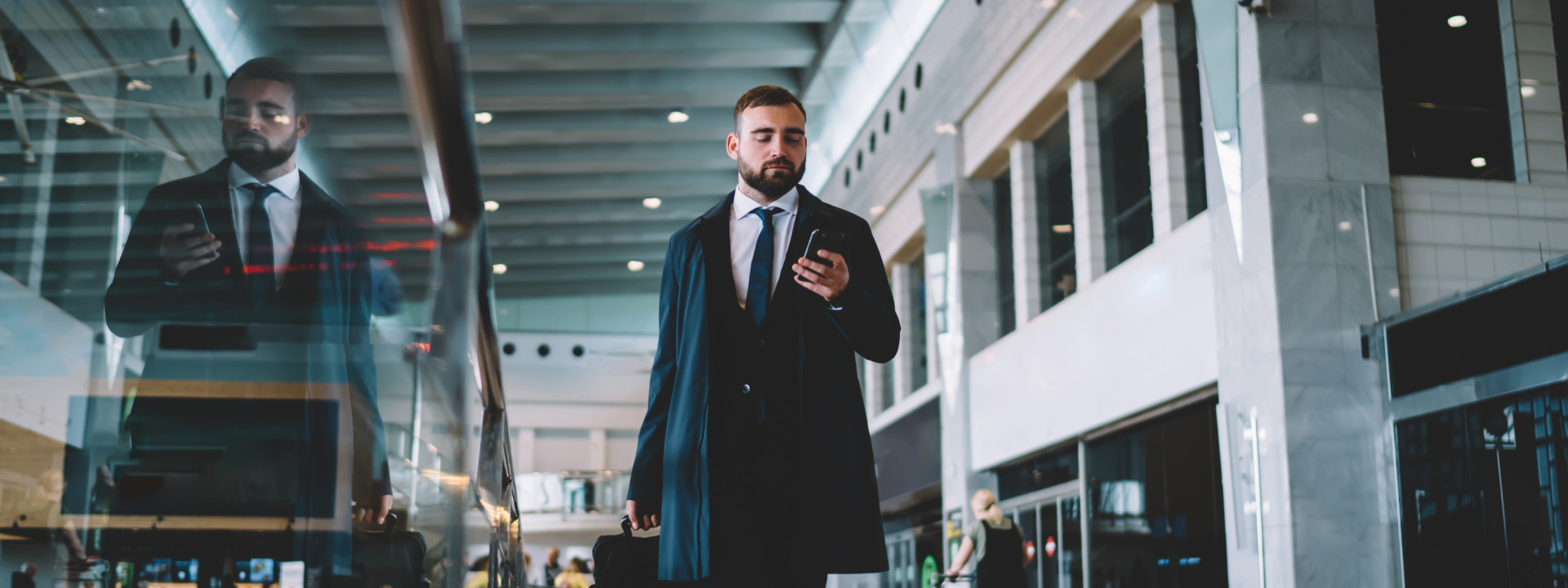 A person in a suit holding a phone